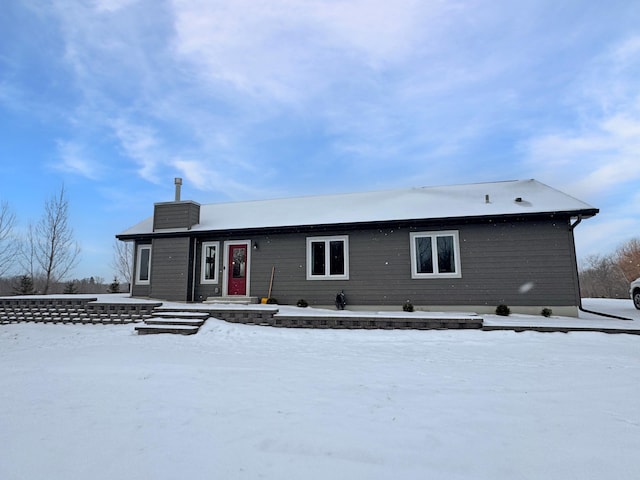 view of snow covered rear of property