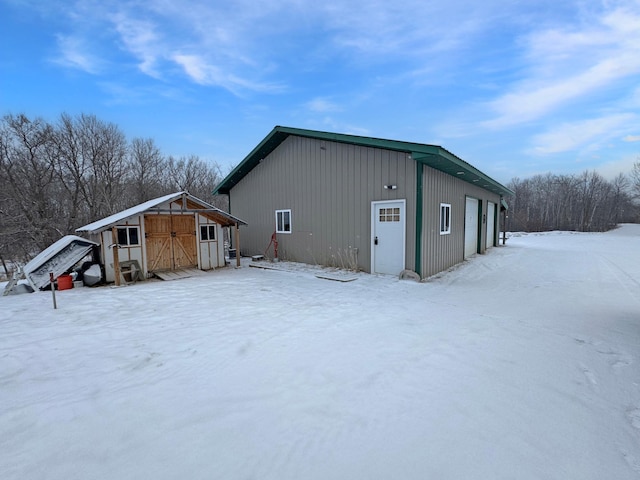 exterior space with a garage and an outbuilding