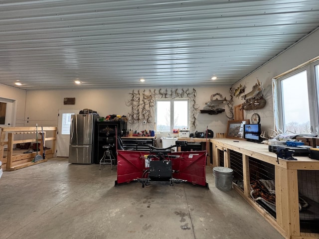 miscellaneous room featuring concrete flooring and a workshop area