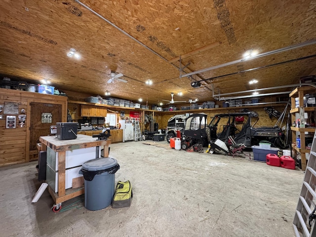 garage with a garage door opener and a workshop area