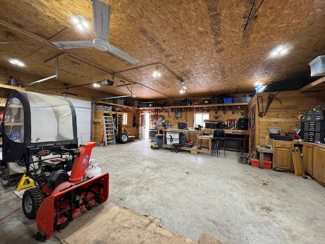 garage with a garage door opener and a workshop area