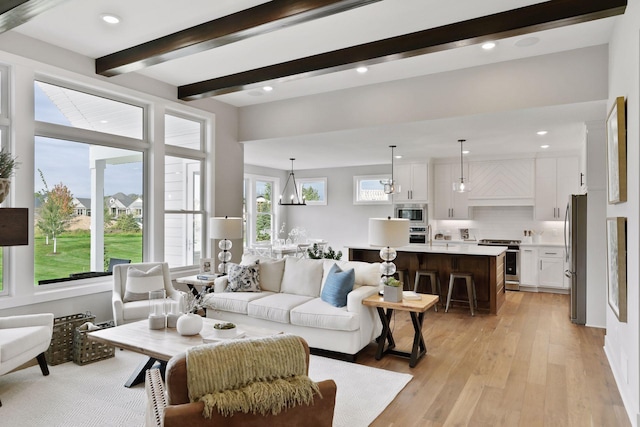 living room with light hardwood / wood-style floors and beam ceiling