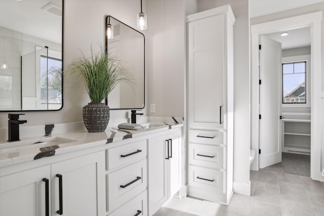 bathroom featuring toilet, tile patterned floors, and vanity