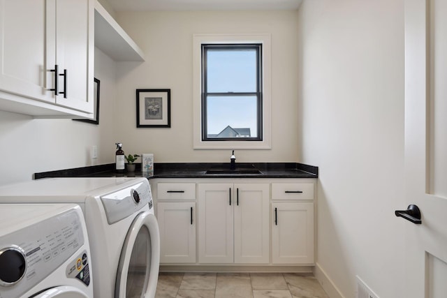 washroom featuring cabinets, separate washer and dryer, and sink