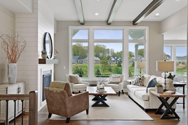 living room featuring beam ceiling, a fireplace, and hardwood / wood-style flooring