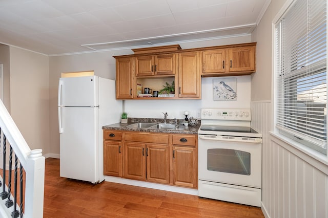 kitchen featuring sink, hardwood / wood-style flooring, and white appliances