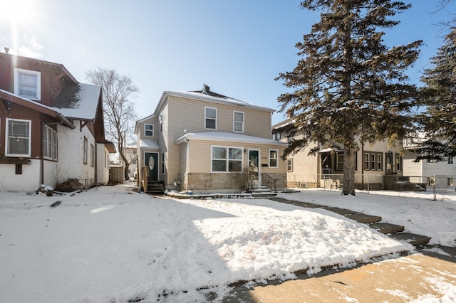 view of snow covered rear of property