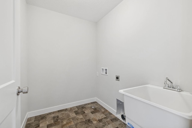 laundry area featuring sink, hookup for a washing machine, hookup for an electric dryer, and a textured ceiling