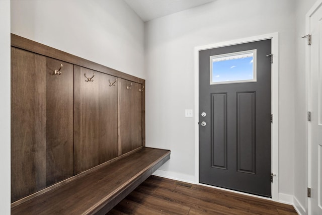 mudroom with dark wood-style floors and baseboards