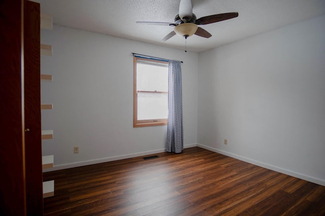 unfurnished room with a textured ceiling, ceiling fan, and dark hardwood / wood-style flooring