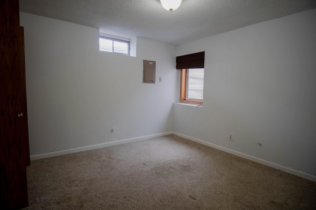 carpeted empty room with a textured ceiling