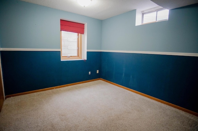 carpeted spare room featuring a textured ceiling