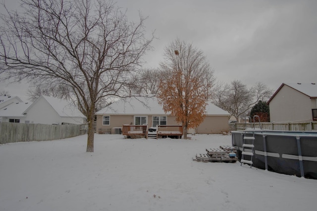 snow covered house featuring a pool side deck