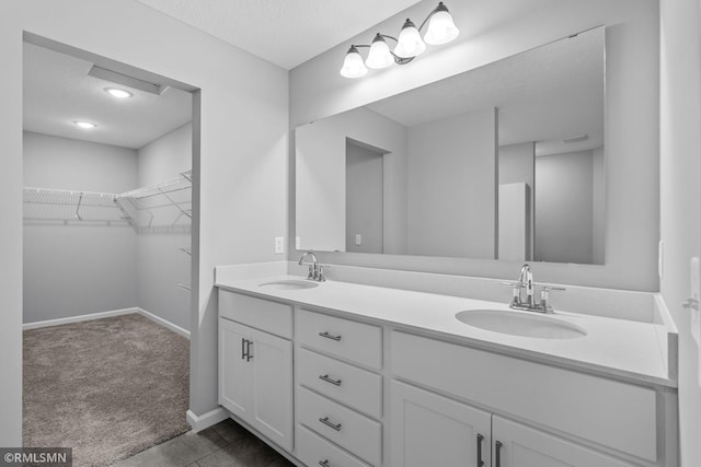 bathroom featuring a textured ceiling, vanity, and tile patterned flooring