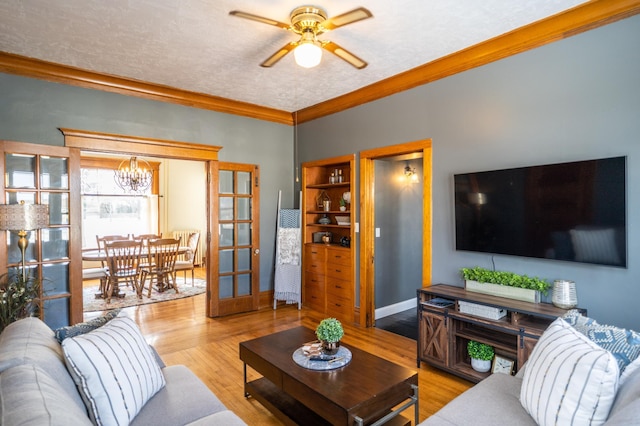 118 Chestnut St, Lake City, MN 55041 - living area with a chandelier, ceiling fan, wood finished floors, and ornamental molding