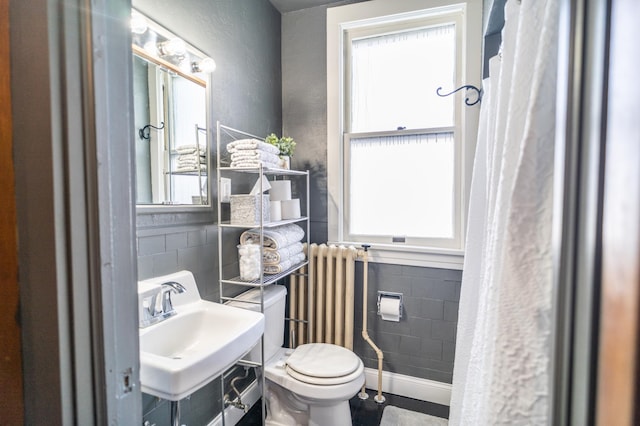 118 Chestnut St, Lake City, MN 55041 - bathroom with tile walls, radiator, a textured wall, and a wainscoted wall
