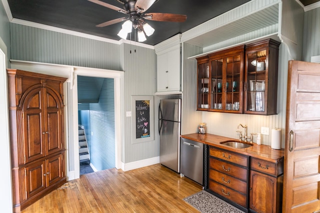 118 Chestnut St, Lake City, MN 55041 - kitchen with stainless steel appliances, light wood-type flooring, ceiling fan, glass insert cabinets, and crown molding