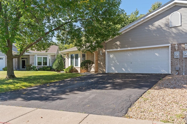 ranch-style home with a front yard and a garage