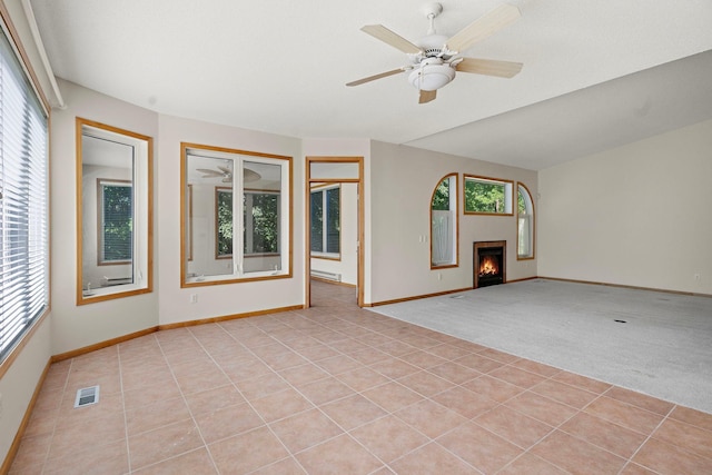 unfurnished living room with light tile patterned floors and ceiling fan