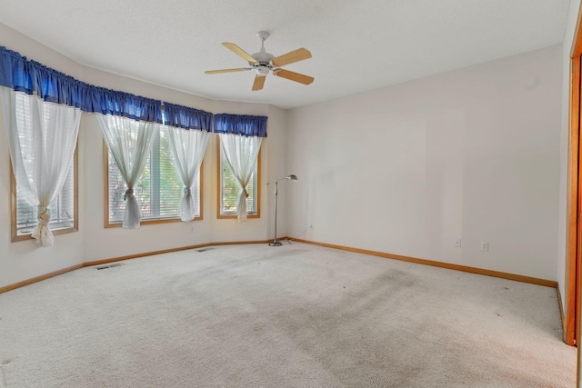 carpeted empty room featuring ceiling fan