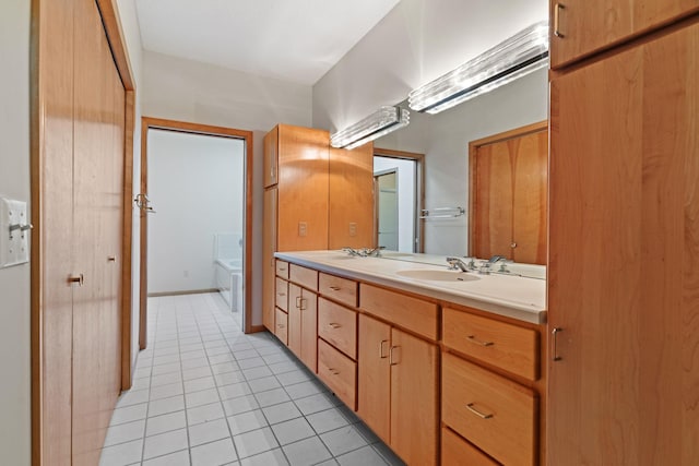 bathroom featuring vanity, tile patterned floors, and a bathing tub