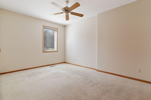 unfurnished room featuring ceiling fan, carpet floors, and a textured ceiling