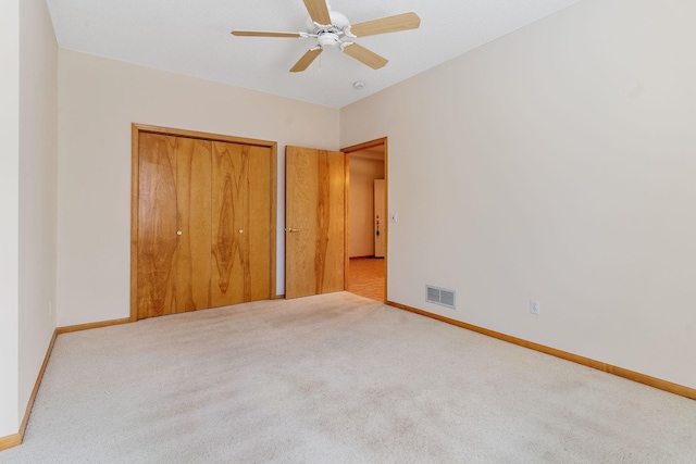 unfurnished bedroom with ceiling fan and light carpet