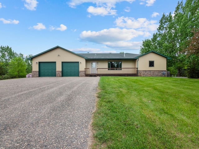 ranch-style home featuring a garage, a front lawn, and a wooden deck