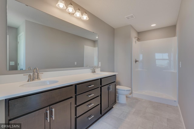 bathroom with toilet, vanity, and a shower