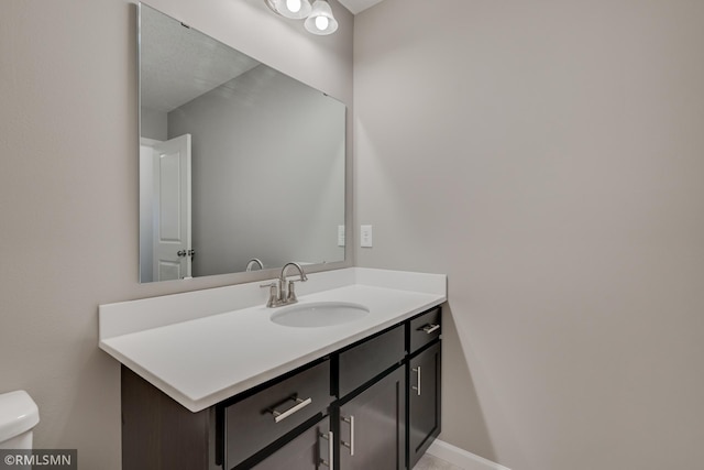 bathroom with toilet and vanity