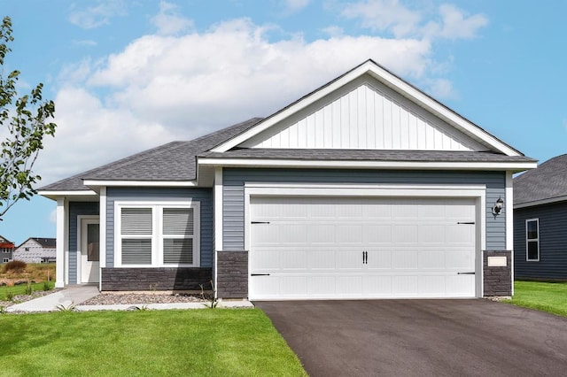 view of front of home featuring a garage and a front yard