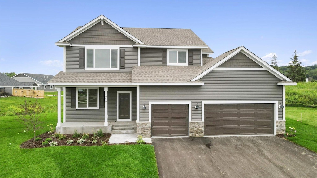 craftsman house with a garage, a front lawn, and covered porch