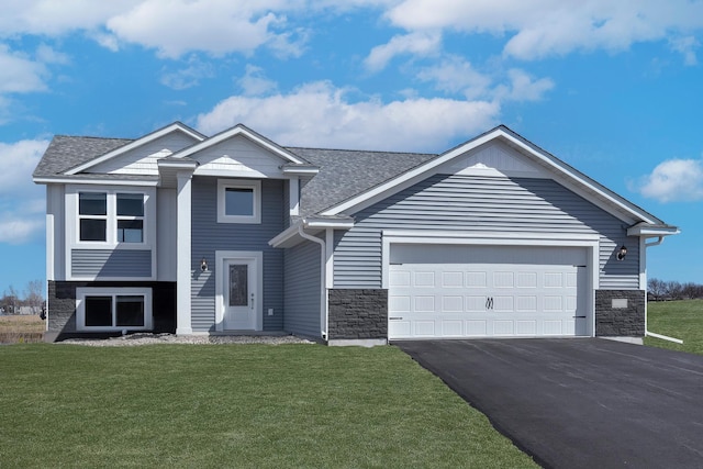 view of front of home featuring a front lawn and a garage