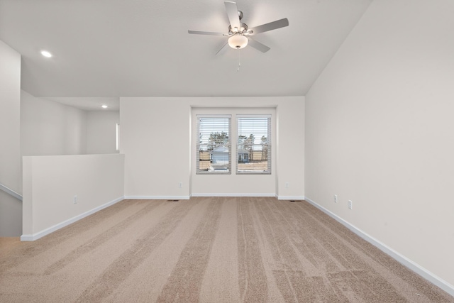 spare room featuring light colored carpet and ceiling fan