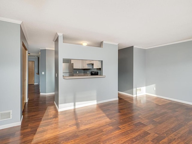 unfurnished living room featuring dark hardwood / wood-style flooring and ornamental molding