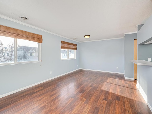 empty room featuring crown molding and dark hardwood / wood-style floors