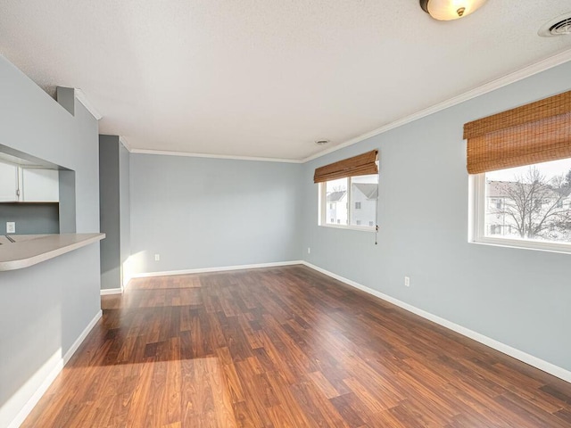 unfurnished living room with hardwood / wood-style flooring and crown molding