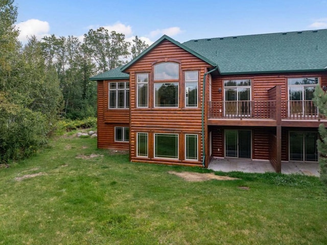 rear view of house featuring a yard and a patio area