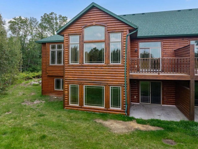 back of property with a lawn and a patio