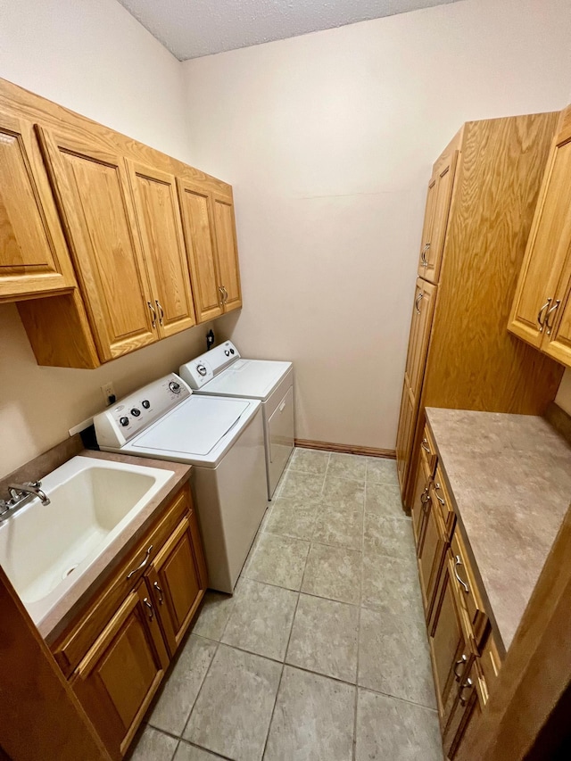 laundry room with sink, cabinets, and independent washer and dryer