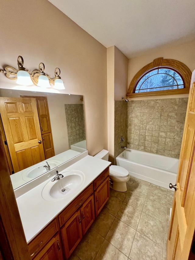 full bathroom featuring toilet, vanity, tile patterned flooring, and tiled shower / bath combo