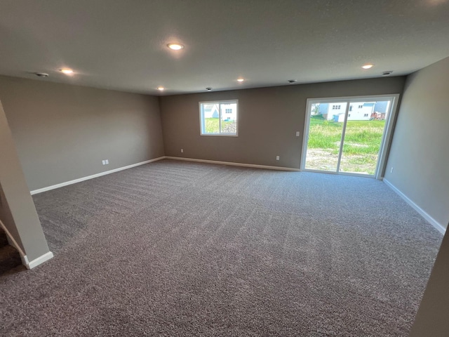 carpeted empty room with a healthy amount of sunlight