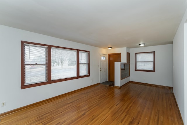 unfurnished living room with wood-type flooring