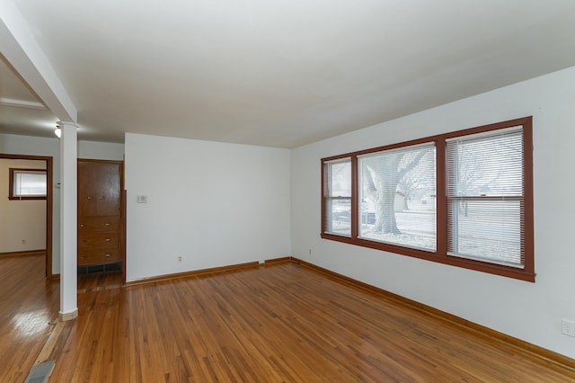 spare room with hardwood / wood-style floors