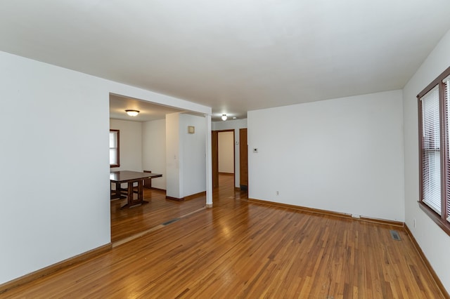 unfurnished room with hardwood / wood-style flooring