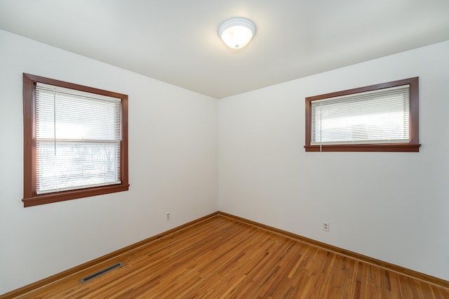 spare room featuring hardwood / wood-style floors