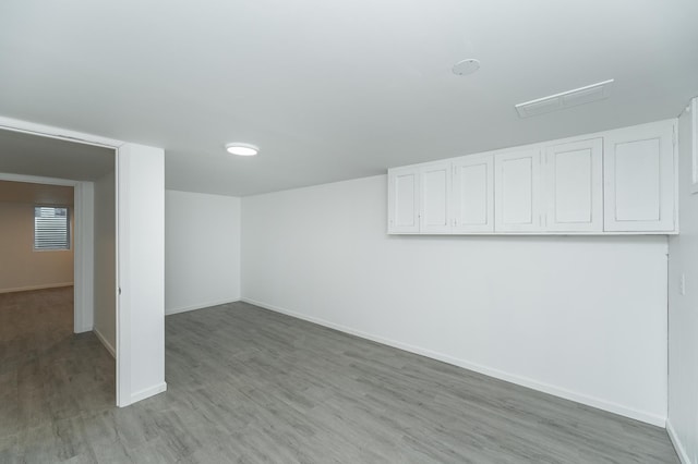 basement with light hardwood / wood-style floors