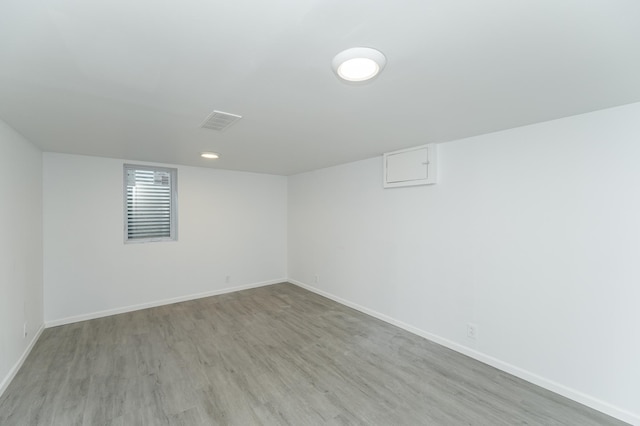 basement with light hardwood / wood-style flooring