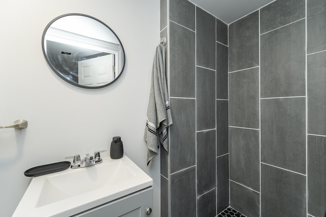 bathroom with vanity and tiled shower