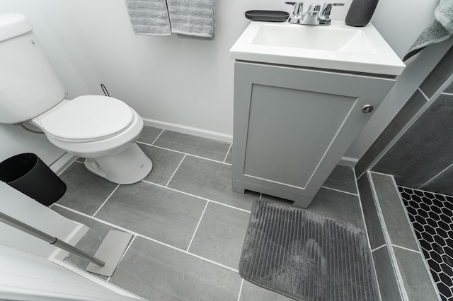 bathroom with tile patterned floors, vanity, and toilet